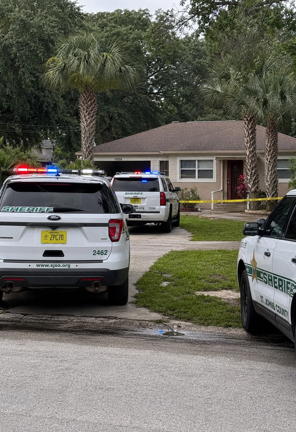 AI-generated editorial image of sheriff vehicles outside a Florida home, used to represent a St. Augustine chase ending at an occupied residence.
