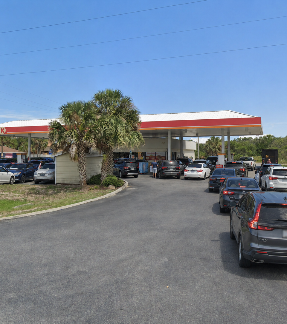 Ai generated: Busy Circle K gas station in St. Augustine with several cars lined up near the pumps on a sunny day.