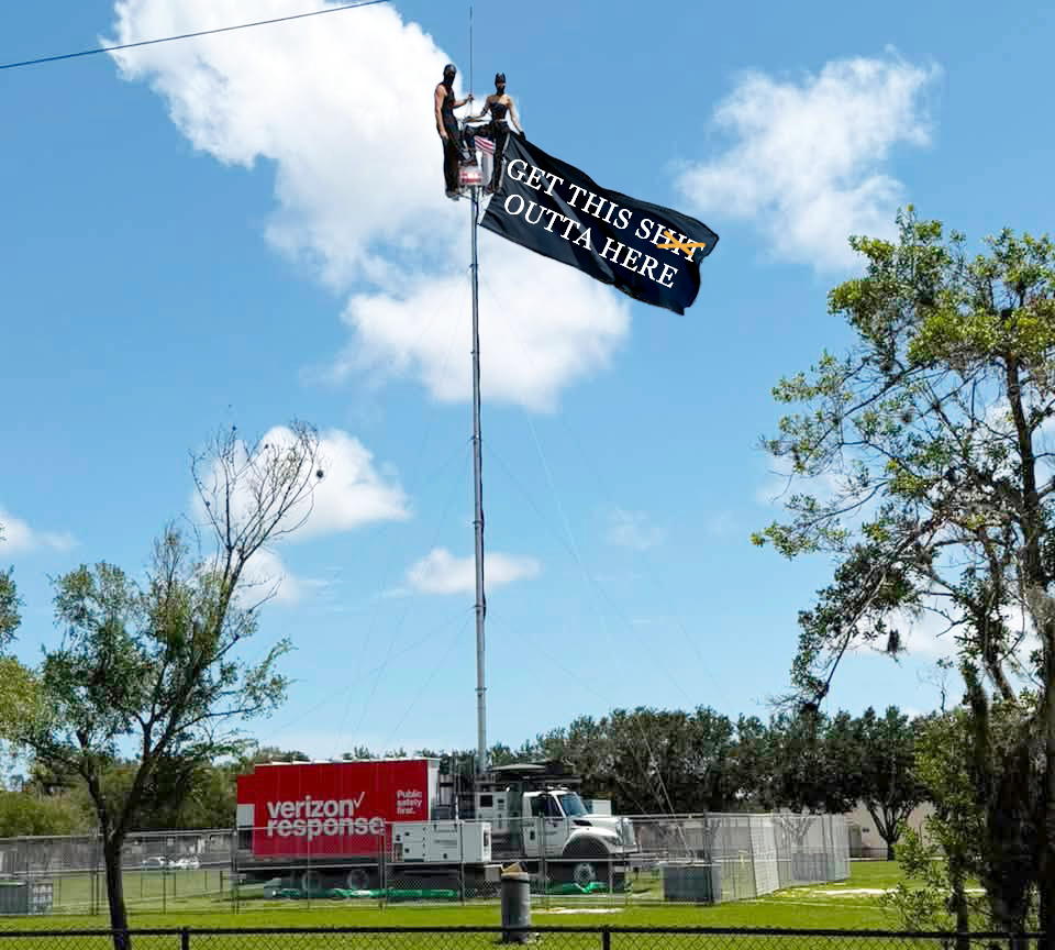 Satirical image of two protesters on top of a temporary Verizon cell tower in Francis Field holding a black banner that says “GET THIS SHIT OUTTA HERE.”